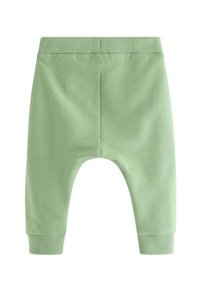 Πράσινο βαμβακερό παντελόνι με απαλό υφή, ελαστική μέση και ριμπ μανσέτες. Ο σχεδιασμός έχει χαλαρή εφαρμογή και απλή, αδιάκοπη πλάτη.