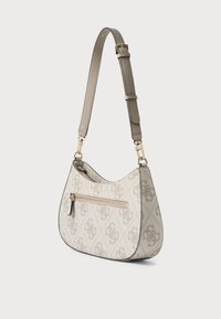 Jasnobeżowa torba na ramię z charakterystycznym wzorem logo. Posiada gładki pasek ze skóry i kieszeń na zamek z przodu.