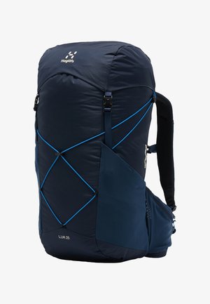 Sac à dos de randonnée Haglöfs L.I.M 25 bleu marine avec cordons élastiques bleus, poches latérales, bretelles rembourrées et ceinture de taille.