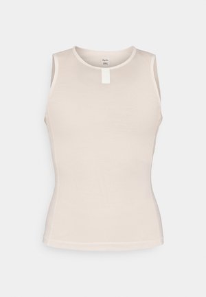 Varrukateta t-särk helesbež, millel on tekstureeritud võrkkangast disain, ümar kaelus ja väike valge silt selja keskel.