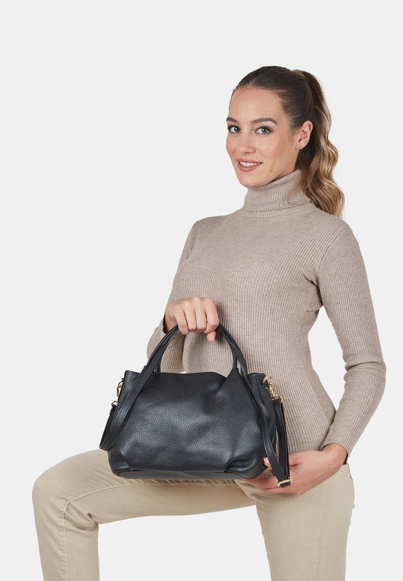 Black leather handbag with a pebbled texture, rounded shape, dual top handles, and detachable shoulder strap. Gold-tone hardware accents.