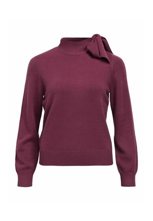 Pull en tricot bordeaux avec un col haut et un détail de nœud sur le côté. Comprend des manches longues et un ourlet ajusté en bas. Texture douce.