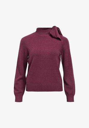 Burgundy knit sweater with a high neck and side bow detail. Features long sleeves and a fitted bottom hem. Soft texture.