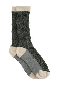 Calze lavorate a maglia di colore verde scuro con un motivo a treccia testurizzato; caviglie e punte di colore beige chiaro; tacco con dettagli grigi. Tessuto morbido, spessore medio.