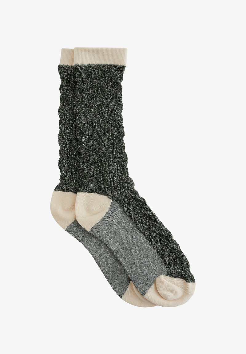 Pletene nogavice v temno zeleni barvi z teksturiranim kablom; svetlo bež manšete in prsti; sivi vložki na peti. Mehka tkanina, srednje debeline.