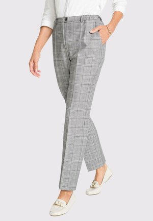 Pantaloni grigi a quadri con vestibilità tailored, dotati di vita alta, tasche anteriori e una texture del tessuto liscia. Abbinati a mocassini bianchi.