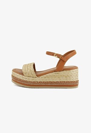 Brown platform sandals with braided rope detailing and a tan strap. Features a rounded toe and a textured wedge heel. Gold buckle accent.