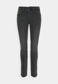 Musthave teksased püksid sirge lõikega, viie taskuga ja diskreetsete õmblustega õmblustes. Kanga pind on sile, kergelt tekstureeritud.
