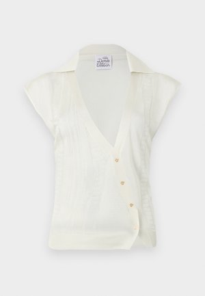 Λευκό αμάνικο πλεκτό τοπ με V-λαιμόκοψη, γιακά, κάθετες υφασμάτινες ρίγες και τέσσερα μικρά διακοσμητικά κουμπιά στο μπροστινό μέρος.