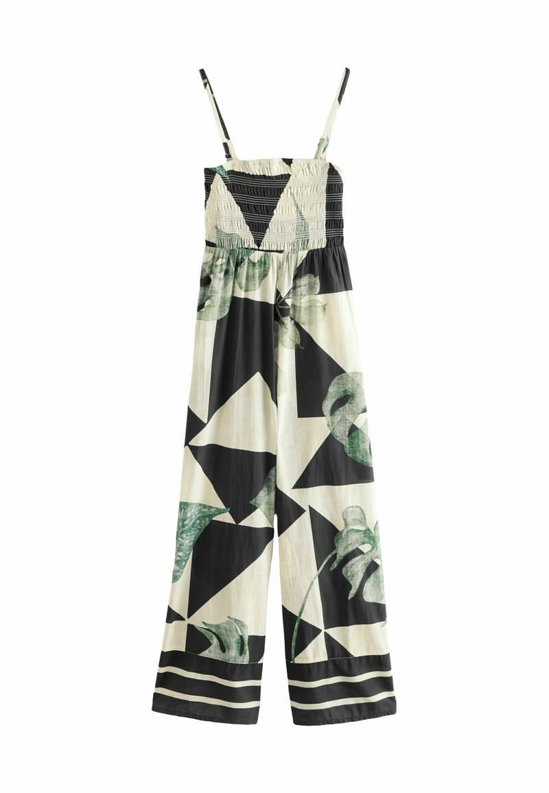Combinaison sans manches à jambes larges avec corsage froncé, motif géométrique noir et crème, accents de feuilles vertes et fines bretelles.