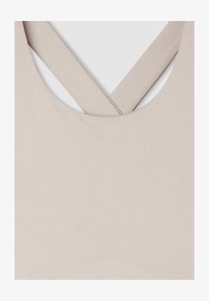 Reggiseno sportivo beige con una texture liscia, spalline larghe che formano una forma a X sul retro e un colletto arrotondato.