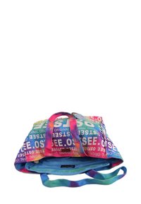 Sac fourre-tout coloré présentant un motif tie-dye avec des teintes bleues, roses et jaunes, et du texte en gras avec des mots comme "original" et "voir".