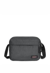 Sac à épaule en tissu gris avec une forme plate et rectangulaire, doté d'une seule sangle réglable et d'une poche zippée à l'avant. Logo Eastpak visible.