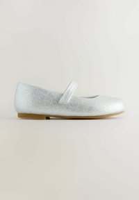 Silver glitter ballet flats with a rounded toe, flat heel, and a Velcro strap across the instep. Smooth texture with a solid tan sole.