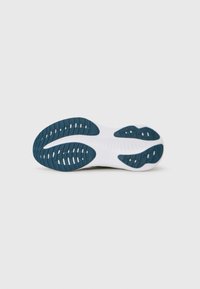 Semelle de sneaker avec une base blanche texturée et des accents en caoutchouc bleu, affichant un motif de rainures pour l'adhérence.