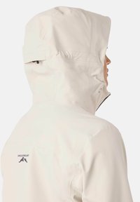 Light beige waterproof jacket with a high collar, adjustable hood, and black zipper accents. Features a logo on the back. Smooth texture.
