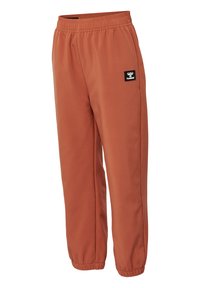 Roestkleurige joggingsbroek van zacht stof, met een elastische tailleband, taps toelopende boorden en een zwart logo-opdracht aan de zijkant.