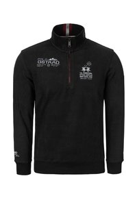 Černý flísový pulovr s vysokým límcem, půlzipem, vyšívanými logy v bílé a červené barvě a žebrovanými manžetami a lemem. Měkká textura.