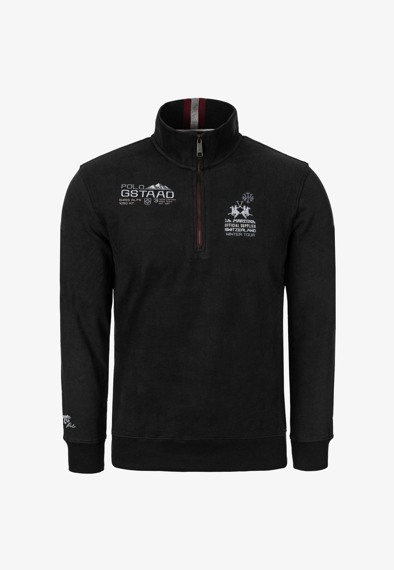 Musta fleeceneule korkealla kauluksella, puolivetoketjulla, valkoisilla ja punaisilla kirjotuilla logoilla sekä resorikäsissä ja -helmassa. Pehmeä pinta.