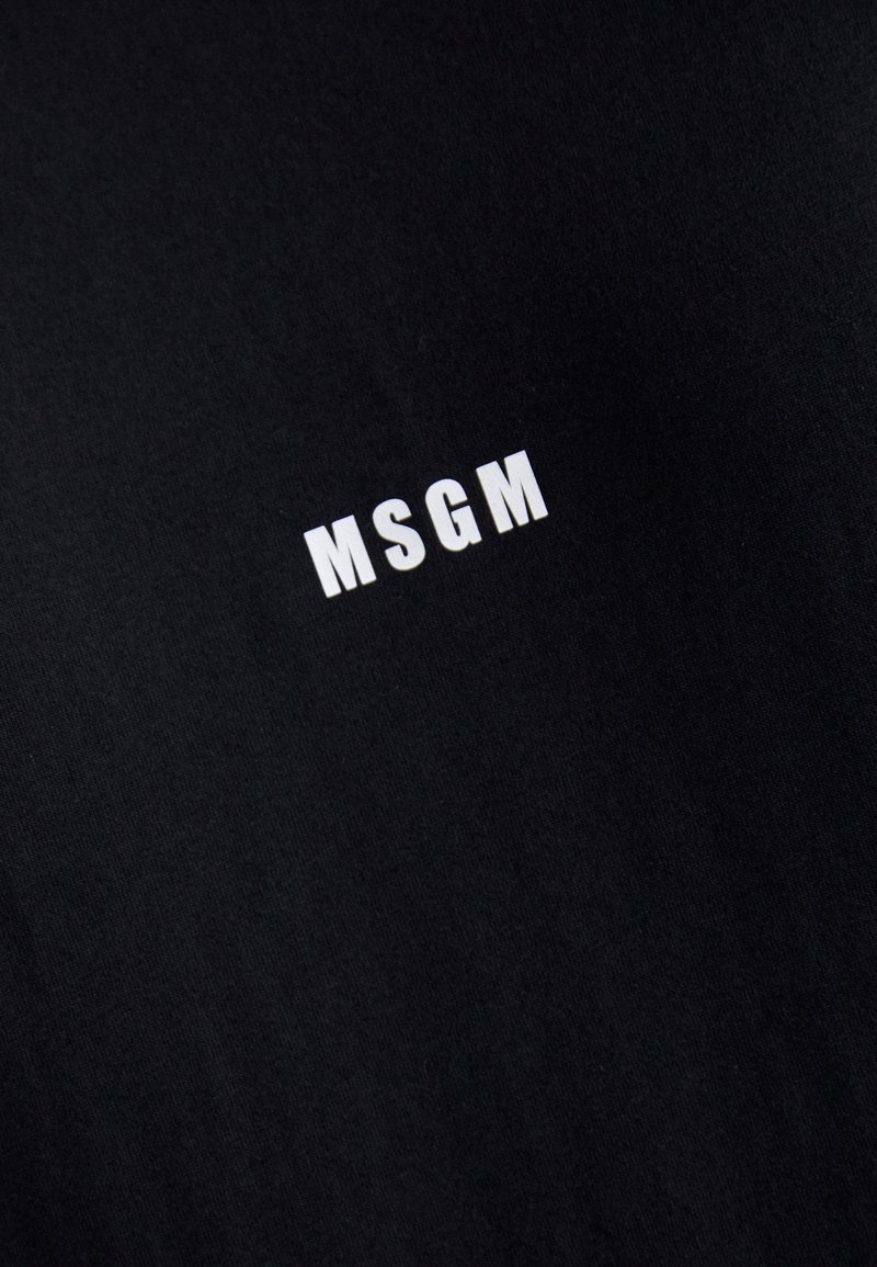 Black cotton T-shirt featuring a white "MSGM" logo printed on the front. Soft texture with a classic crew neck design.