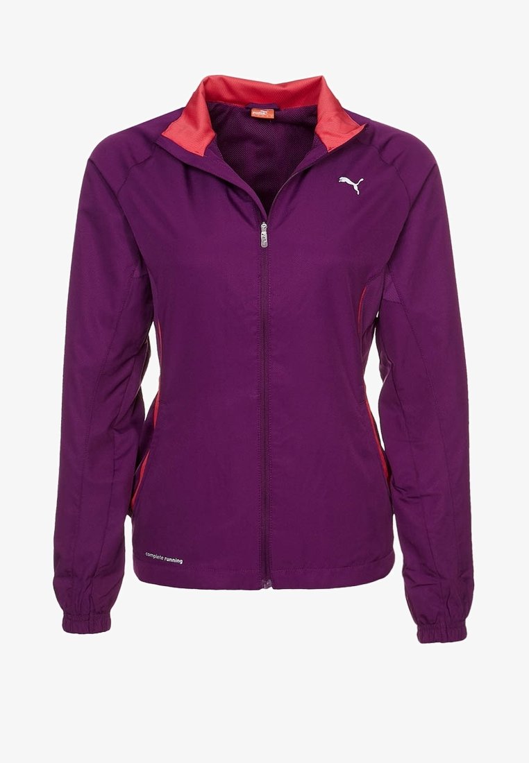 Lila idrottsjacka med dragkedja, röda kragspecifikationer, sidofickor och elastiska muddar. Lätt och ventilerande tyg.