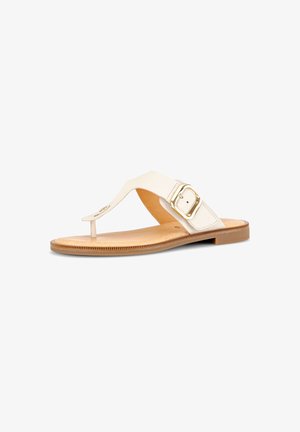 Flat tan sandal with a white leather thong strap, adjustable gold buckle, and a textured sole, shown on a white background.