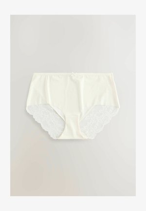 Białe bawełniane majtki z koronkowym wykończeniem po bokach, o miękkiej fakturze i bezszwowym fasonie zapewniającym komfort. Falbany na krawędziach podkreślają detale.