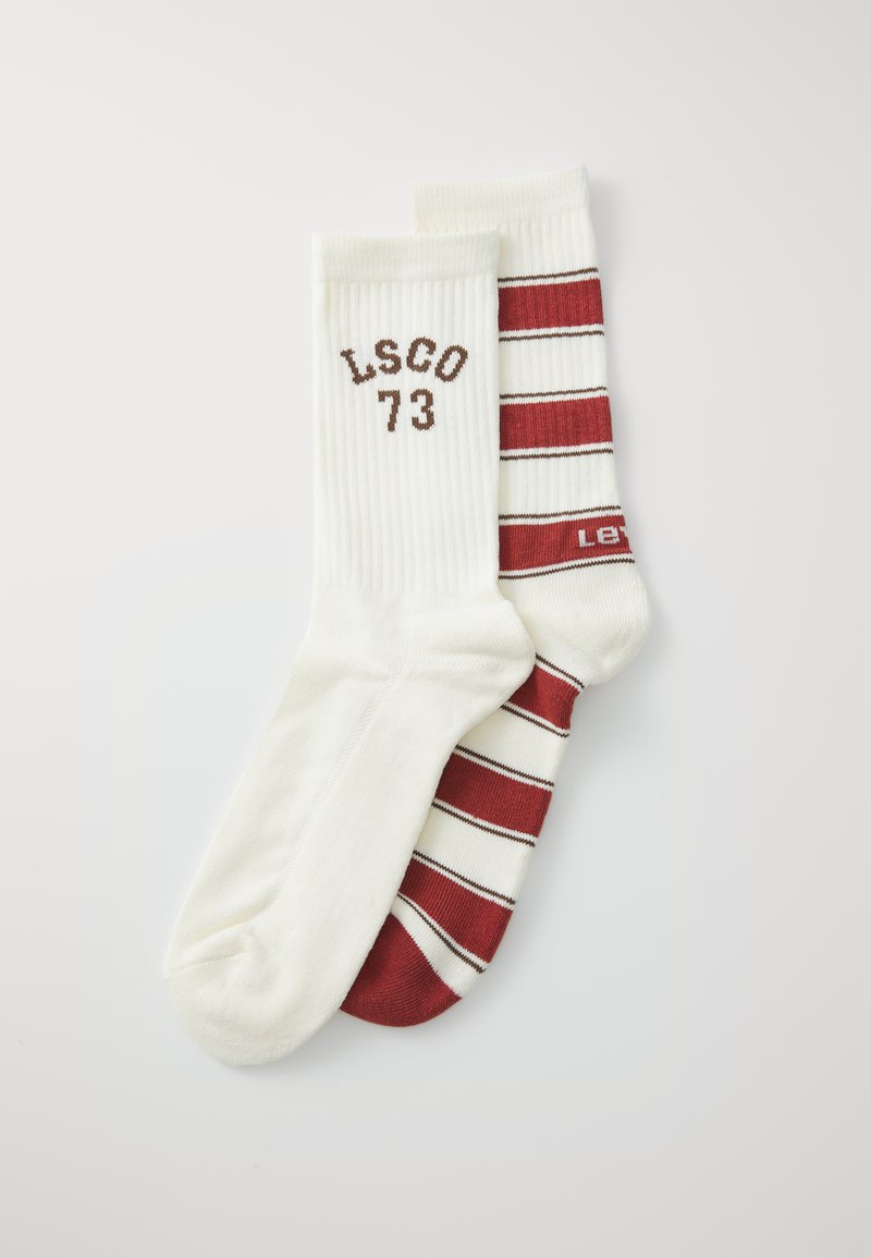 Two pairs of cotton socks. One is solid white with "LSCO 73" printed in brown. The other has red and white stripes with a logo in red.
