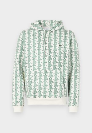 Felpa con cappuccio caratterizzata da un motivo geometrico verde su uno sfondo bianco, polsini e orlo a coste, e un piccolo logo sul petto.