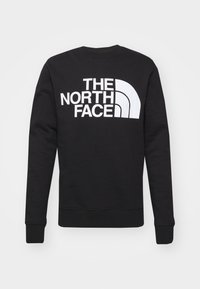 Svart sweatshirt i en bomullsblandning, med en stor vit grafiklogotyp på framsidan, ribbad halsringning, ärmar och fåll.