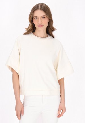 Ivoor kleurige sweatshirt met korte mouwen, een relaxte pasvorm, raglanmouwen en een ronde halslijn. Zachte textuur met minimale merkdetails.