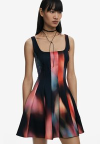 Black and multicolored flared dress with a square neckline, featuring a blend of red, blue, and pink hues in a smooth fabric.