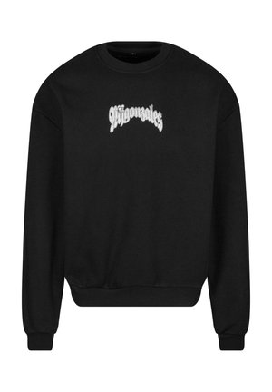 Schwarzer Pullover mit Rundhalsausschnitt und langen Ärmeln. Er hat auf der Vorderseite weißen gestickten Text. Weicher Stoff mit lockerer Passform.