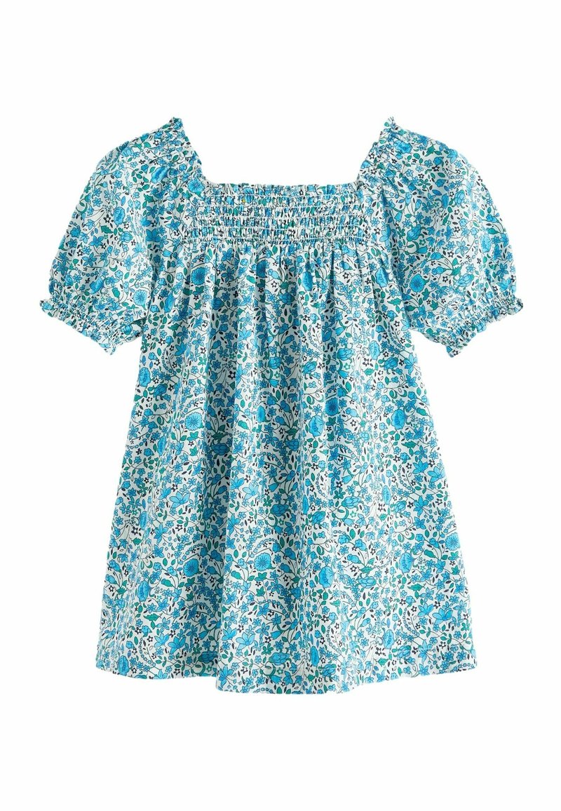 Blouse à imprimé floral bleu et blanc avec encolure carrée et manches courtes bouffantes, présentant un détail smocké sur la poitrine.