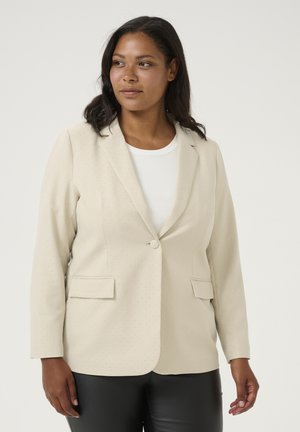 Beiger Blazer mit taillierter Passform, ausgestattet mit einem einzelnen Knopfverschluss und zwei Fronttaschen, veredelt mit einer dezenten gepunkteten Textur.
