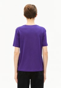 Paarse katoenen T-shirt met een ronde hals en korte mouwen, met een eenvoudig ontwerp en een relaxte pasvorm. Zichtbare stiksels langs de zoom.