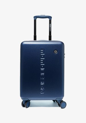 Valigia rigida blu navy con quattro ruote girevoli, manico retrattile e marchio "mimi DESIGN" impresso in verticale.