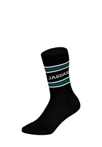Czarne skarpetki za kostkę z poziomymi paskami w kolorze zielonym i białym, z napisem „JAGUARS” na środku pasków. Gładka faktura.