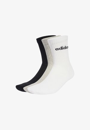 Tri parovi posadačkih čarapa u crnoj, sivoj i bijeloj boji. Izrađene od teksturiranog materijala, imaju rebrasti gornji dio i istaknuto "adidas" brendiranje na bijeloj čarapi.