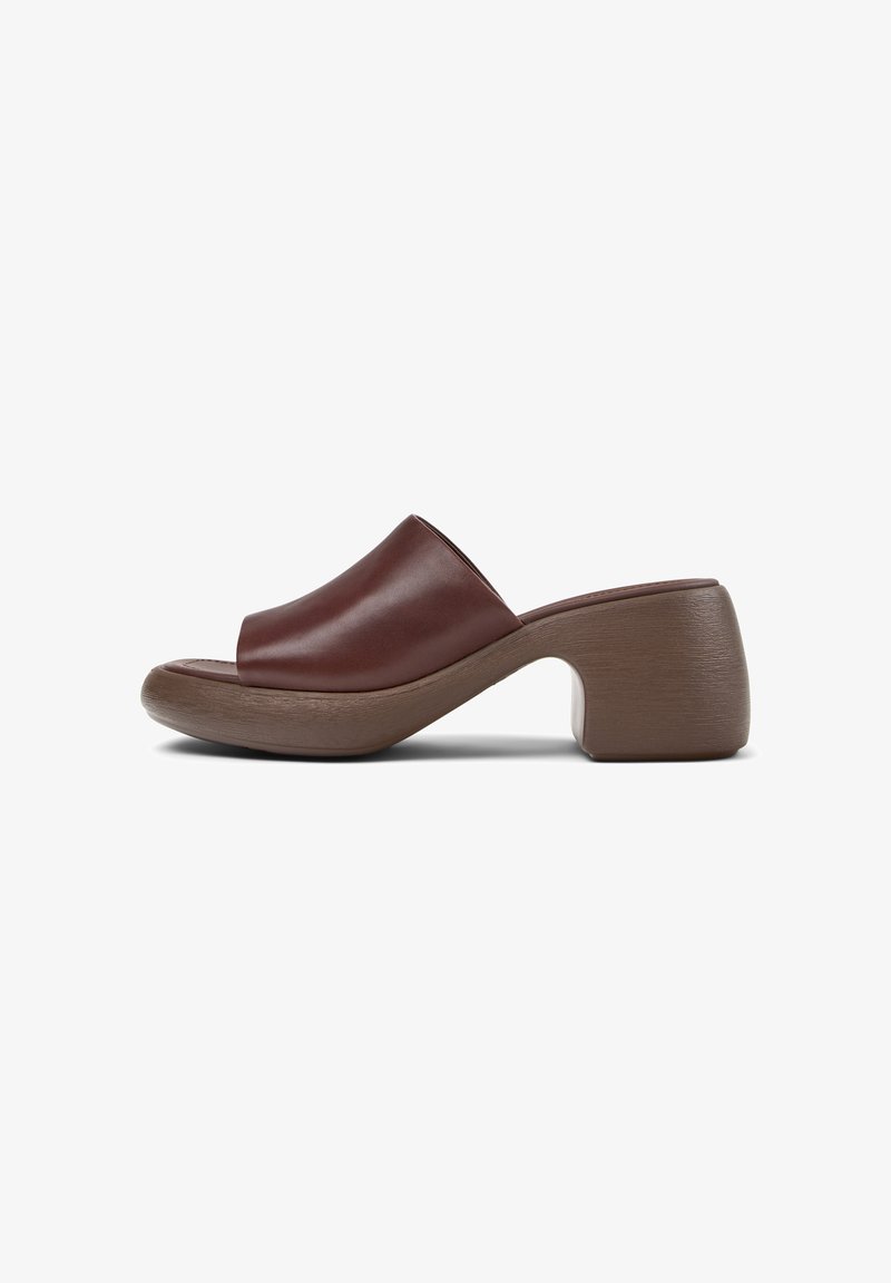 Brown leather open-toe mule with a wide strap, chunky medium heel, and a slightly curved sole on a white background.