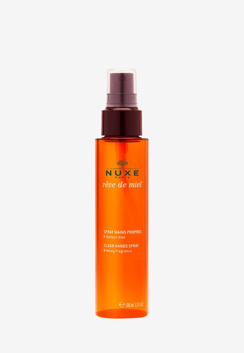 Nuxe Rêve de Miel clean hands spray, orange bottle with brown pump, 100 ml, honey-fragrance hand sanitizer.