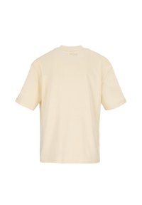 Short-sleeve, cream-colored t-shirt made of cotton with a standard crew neck. Features a printed label on the back near the neck.
