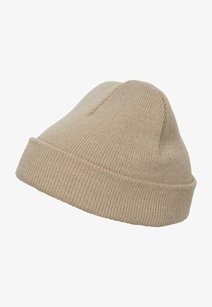 Beige knit beanie with a rounded crown, ribbed cuff, and fine texture, featuring a small top seam detail.