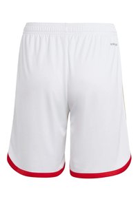 White athletic shorts with a red hem, elastic waistband, and smooth, lightweight fabric. Features minimal branding on the back.