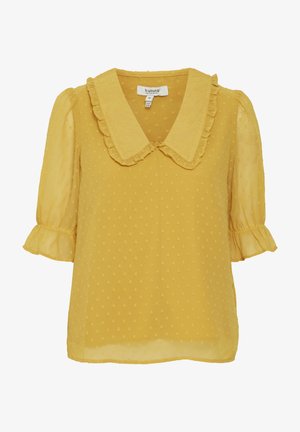 Gelbe Bluse mit strukturierten Punkten, Rüschekragen und kurzen Puffärmeln. Leichter Stoff und dezenter Glanz heben das Design hervor.