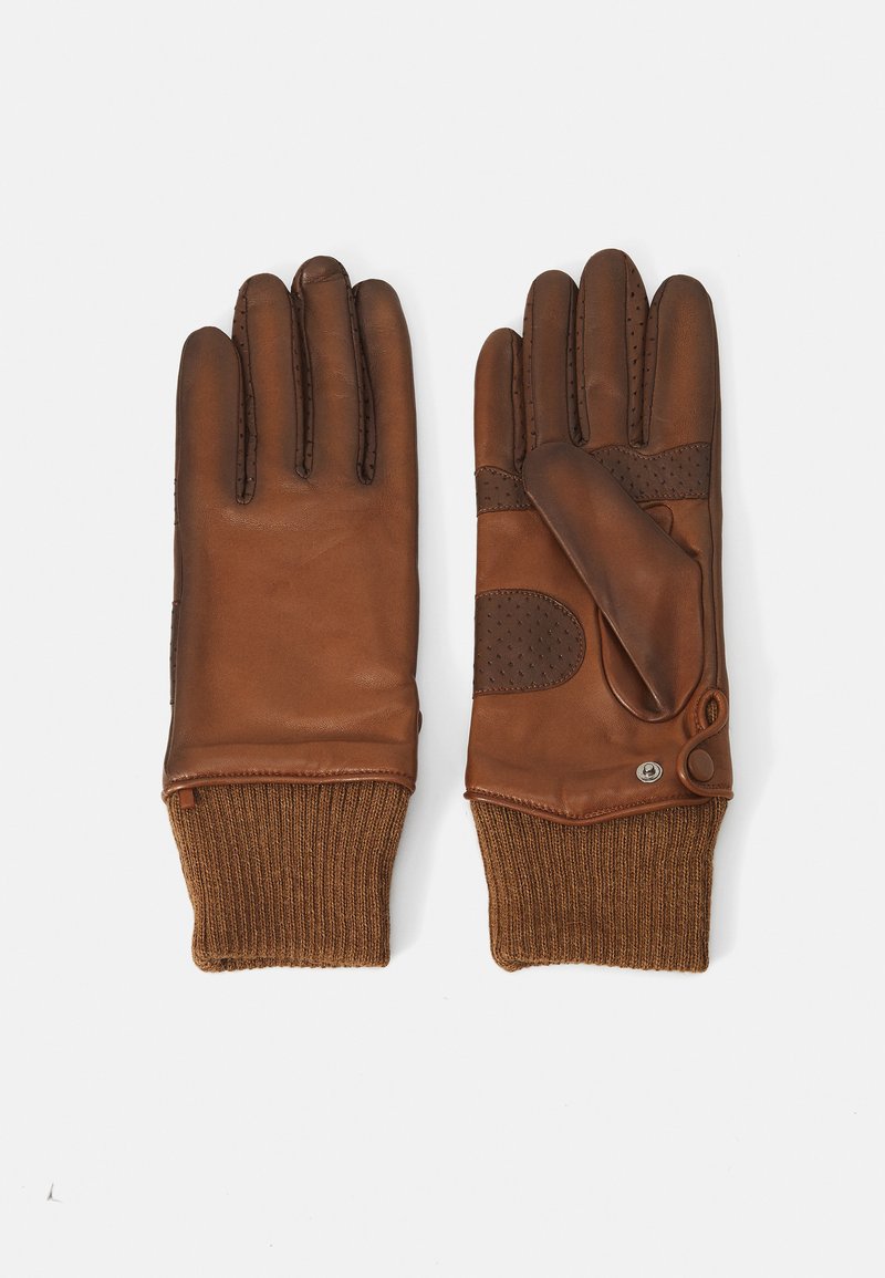 Barna bőrkesztyű ribbed barna kötött mandzsettával, csattal a csuklón és perforált díszítéssel a tenyéren a jobb tapadás érdekében.