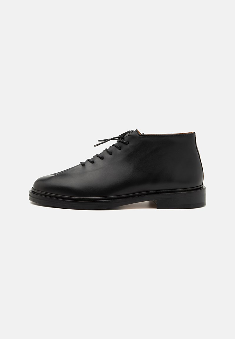 Black leather ankle boots with a rounded toe, lace-up design, and a solid black rubber sole. Smooth texture with minimal detailing.