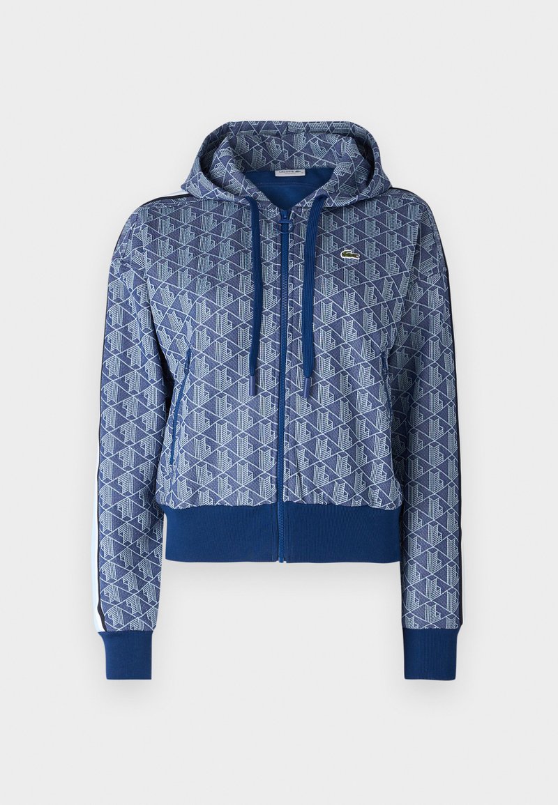 Felpa blu con zip e motivo geometrico, con cordini e polsini a costine. Presenta un logo sul petto. Realizzata in tessuto morbido.