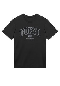 Black cotton t-shirt featuring a bold "TOKYO" graphic in white, with Japanese text below. Round neck and short sleeves, simple design.