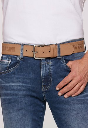 Brown leather belt with embossed "CAMP DAVID" text, silver metal buckle, and stitching detail, worn with blue denim jeans.